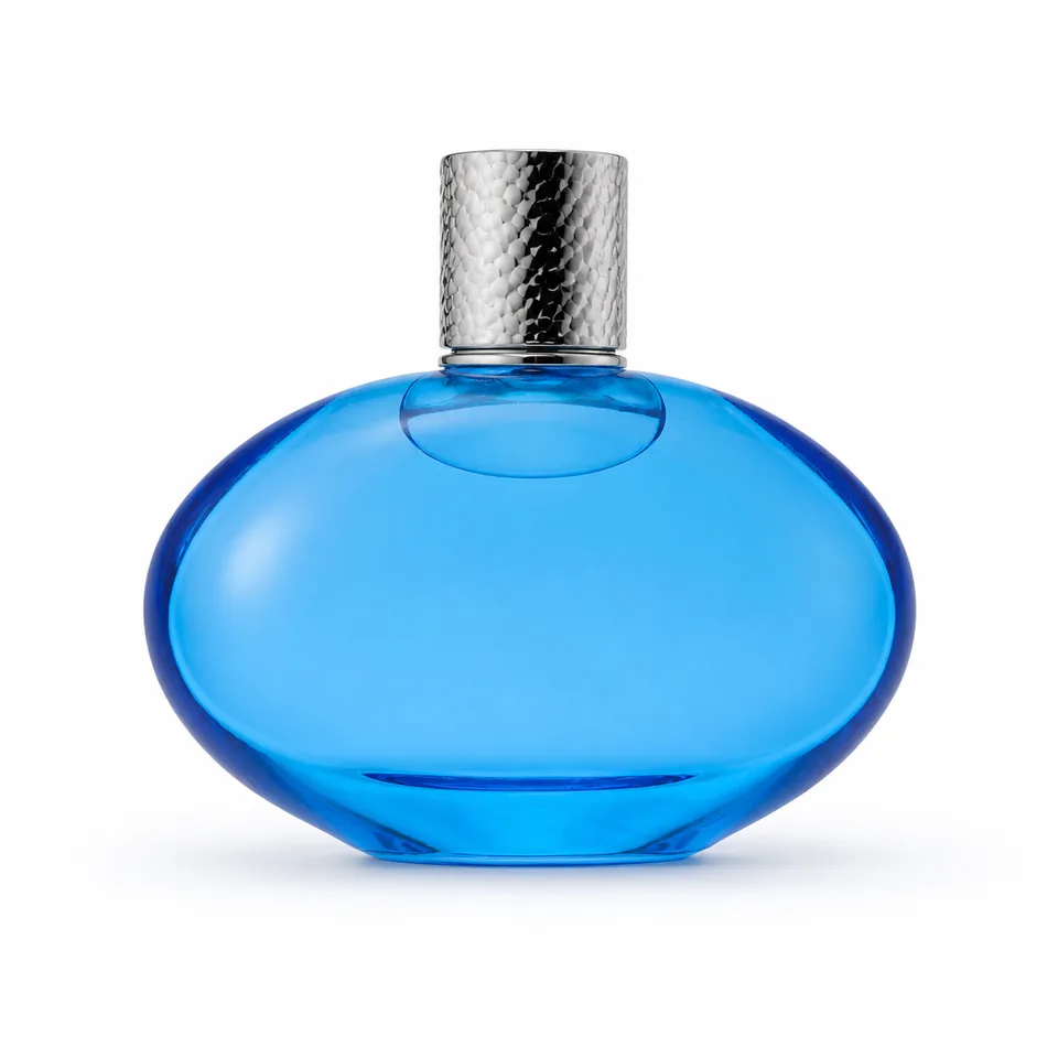 Horizontal oval blue glass perfume bottle with textured silver cap