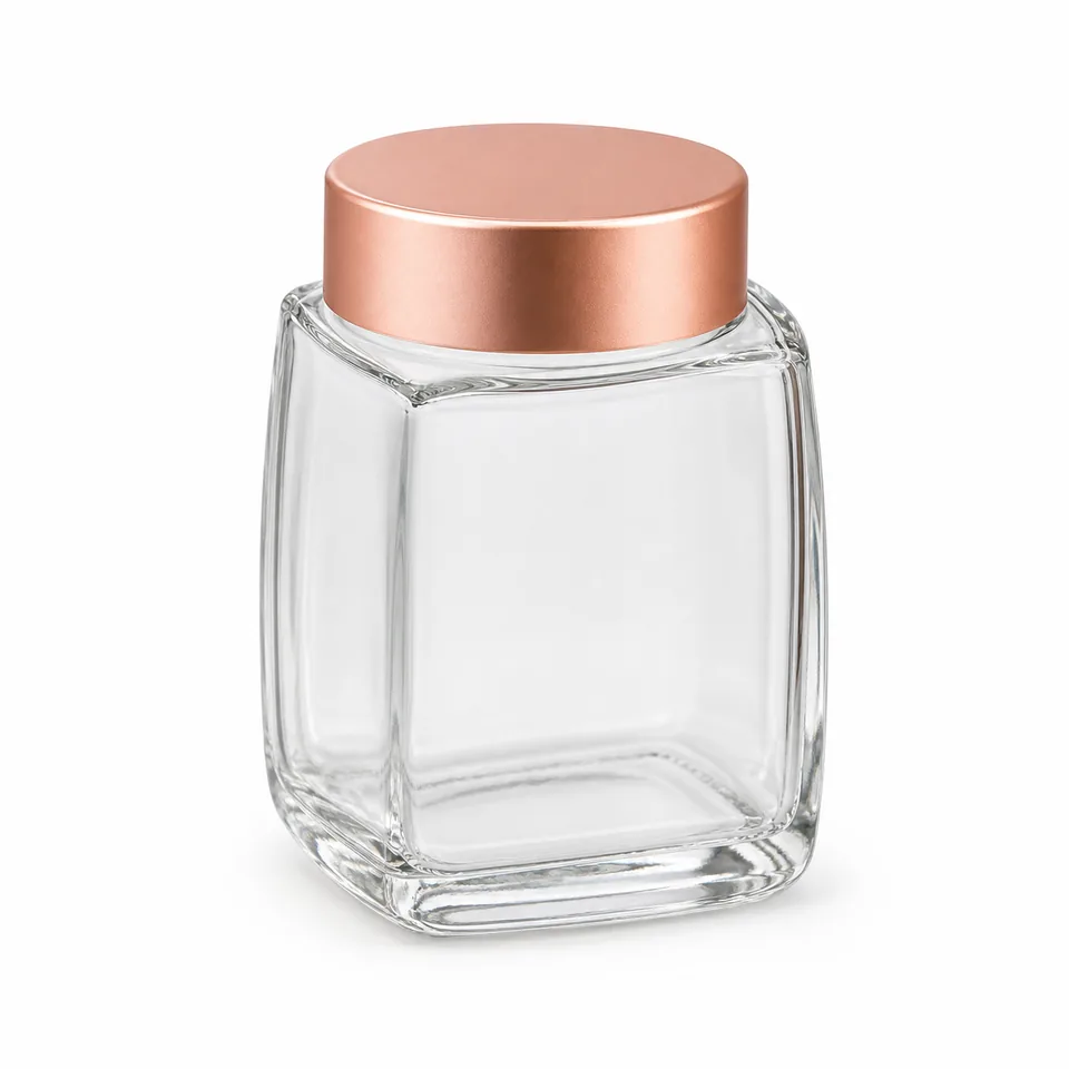 Small rounded-square glass honey jar with rose-gold cap