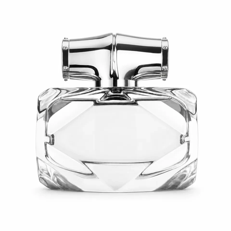 Low wide faceted clear glass perfume bottle with silver bamboo-style cap
